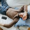 Casual man resting on a sofa at home, illustrating tranquility and relaxation.