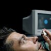 Close-up of a man during an eye examination using advanced medical technology scanner.