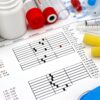 Arrangement of medical equipment, lab tests, and health data on a clinical table.