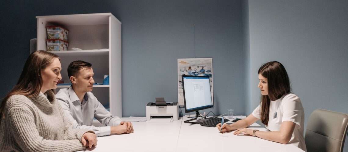 A couple consulting with a doctor in a medical office for a health check-up.