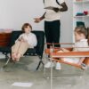 Children engaging in a therapy session with therapist in a modern office.