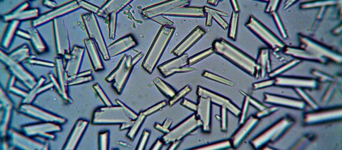 Detailed close-up of crystalline structures under a microscope, showcasing scientific detail.