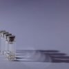 Close-up of lined up vaccine vials casting shadows, symbolizing medical advancements and health.