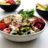 Vibrant vegan Buddha bowl filled with fresh vegetables and healthy ingredients.