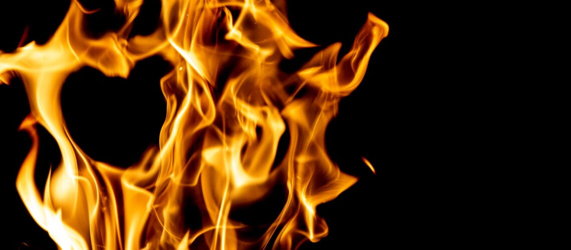 Captivating image of burning flames against a black backdrop, showcasing the dynamic nature of fire.