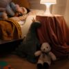 A warm and cozy child's bedroom setting with plush toys and soft lighting creating a peaceful ambiance.