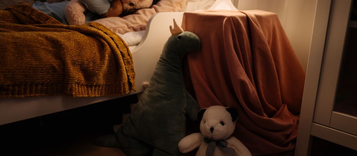 A warm and cozy child's bedroom setting with plush toys and soft lighting creating a peaceful ambiance.