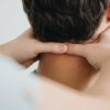 Close-up of a therapist massaging a patient's neck for pain relief and relaxation.