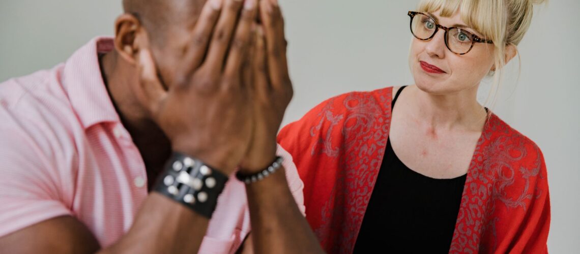 A supportive counseling session between a caring mentor and an emotional individual.