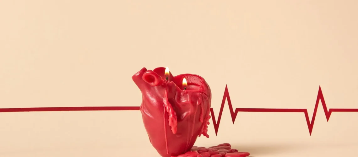 Bougie créative en forme de cœur qui fond avec des flammes allumées, sur fond de tracé ECG symbolisant les battements du cœur.